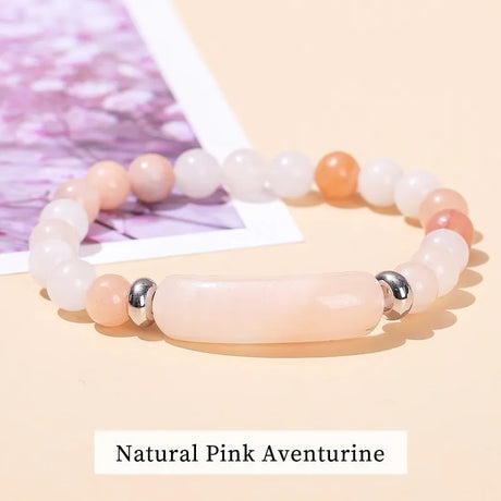 Beaded bracelet with natural pink aventurine stones on a light background