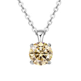 Gold diamond pendant on a silver chain against a white background