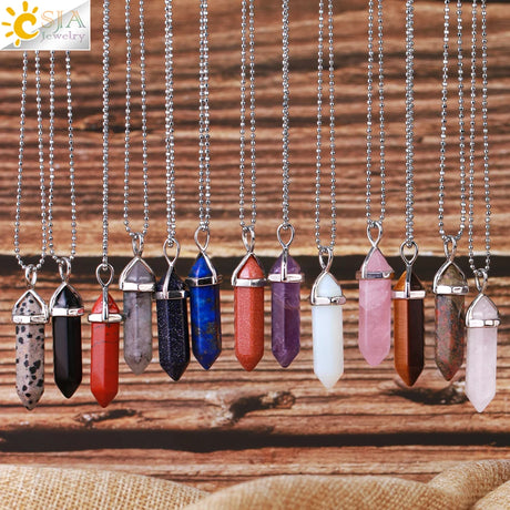 Necklaces with colorful crystal pendants on a wooden surface