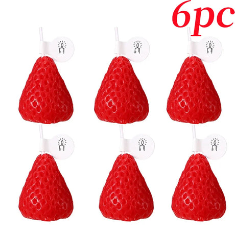 Six red strawberry-shaped candles on white stands with '6pc' text above.