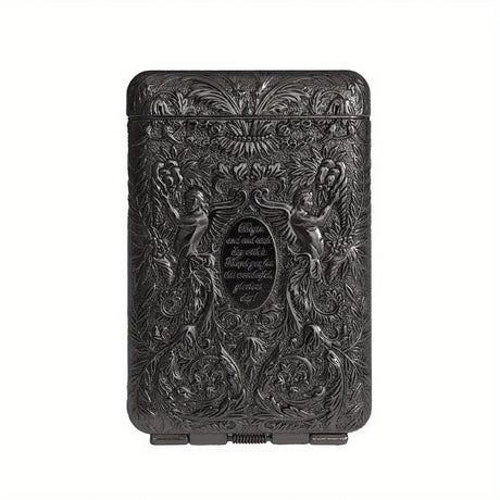 Decorative black metal card case with intricate engravings on a white background