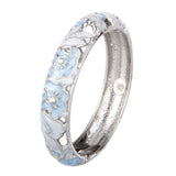 Silver ring with blue floral designs on a white background