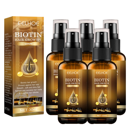 Biotin hair growth serum packaging with multiple bottles on a white background