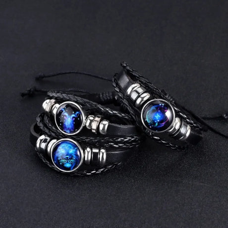 Black braided leather bracelets with blue stone beads on a dark background