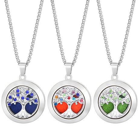 Three tree-shaped locket necklaces with colorful heart designs on a white background