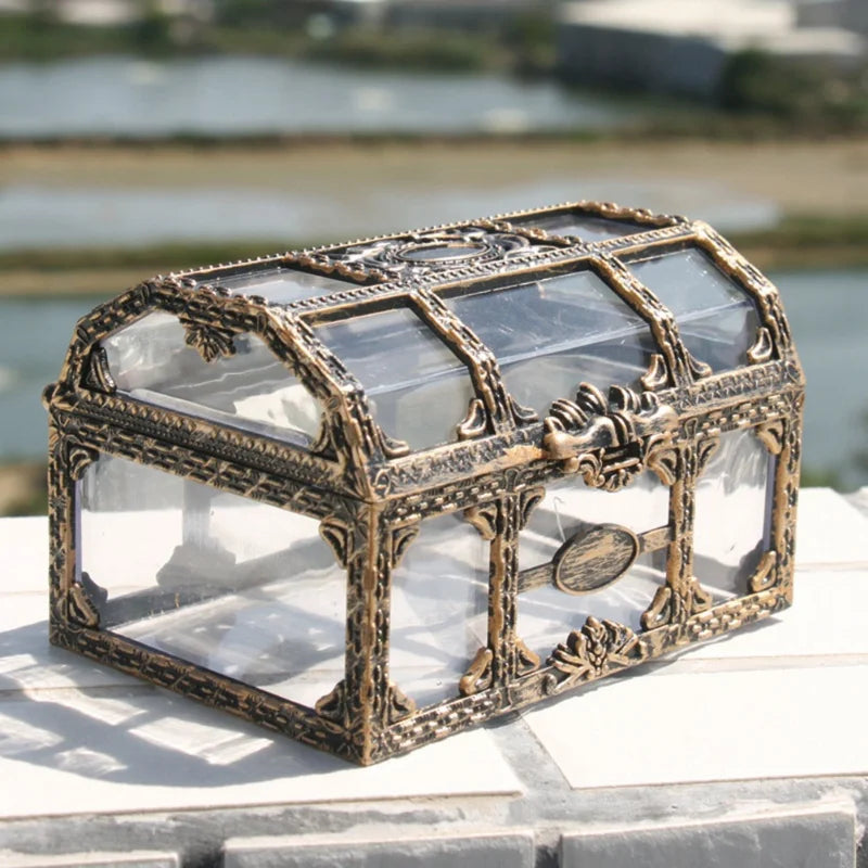Decorative jewelry box with glass panels on a marble surface