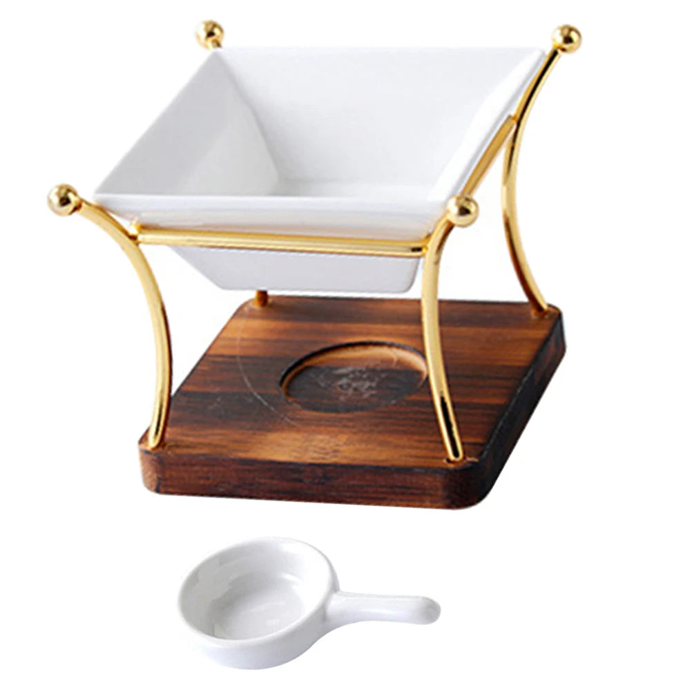 White ceramic bowl with gold rim on a wooden stand, accompanied by a white ceramic ladle.