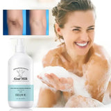 Woman applying soap with a bottle of EELHOE goat milk shower gel in the foreground.