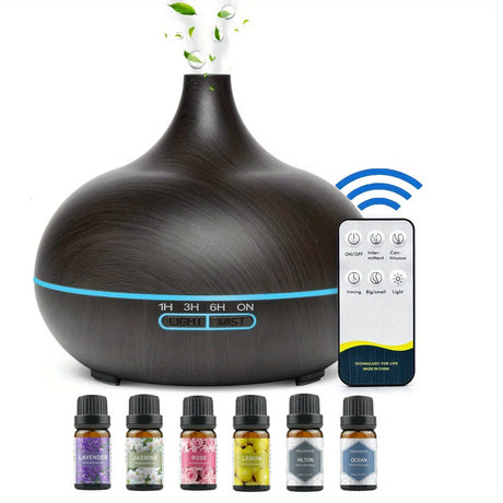 Aromatherapy diffuser with remote control and essential oil bottles on a white background