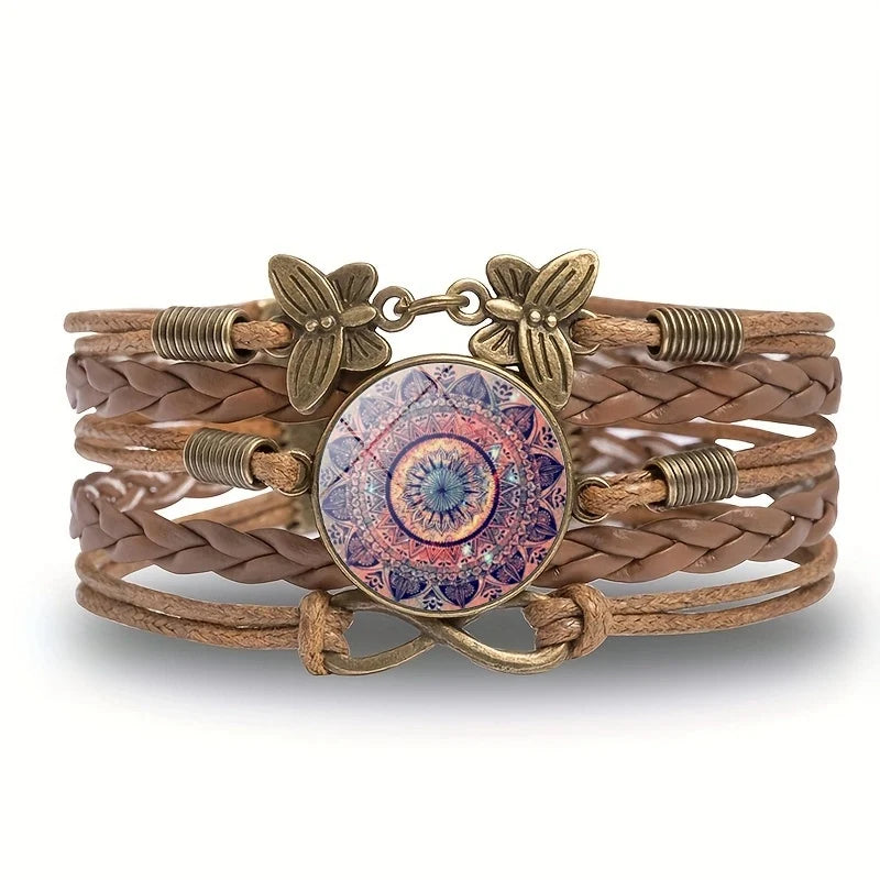 Brown braided bracelet with decorative elements on a white background