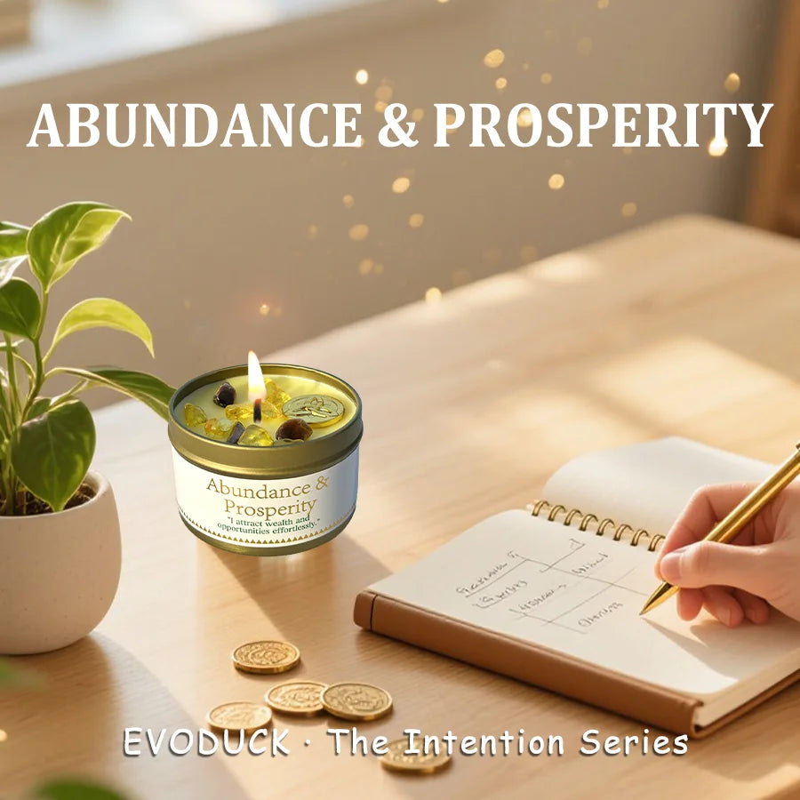 Candle labeled 'Abundance & Prosperity' on a table with a notebook and coins, featuring the brand 'EVODUCK'.