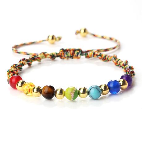 Colorful beaded bracelet with gold accents on a white background
