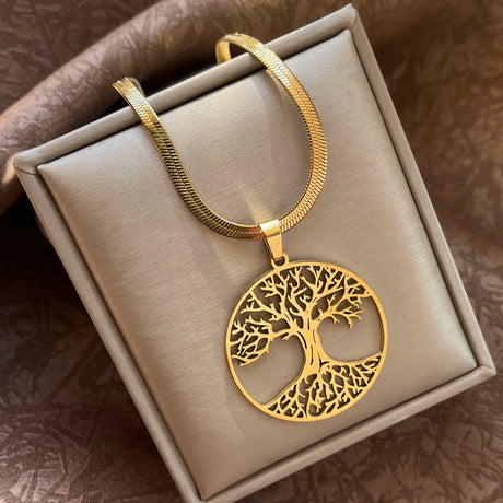 Gold tree of life necklace on a gray jewelry box