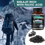 Person hiking in a mountainous area with a bottle of KENOFOR shilajit supplement and fulvic acid shown.