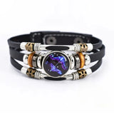 Multilayered bracelet with metallic and leather components on a white background