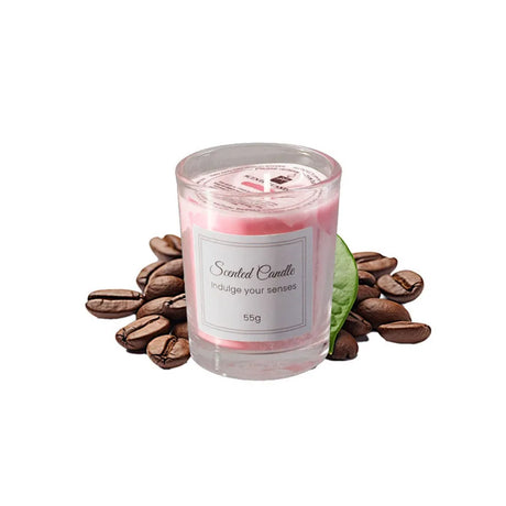 Scented candle with coffee beans and a leaf on a white background