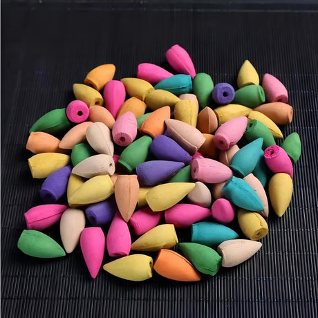 Assorted colorful wooden beads on a dark surface