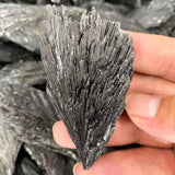 Mineral specimen held in hand with a blurred background
