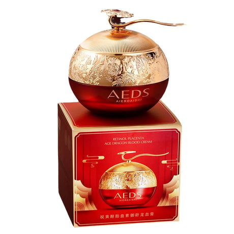 Gold and red AEDS cosmetic container with packaging on a white background