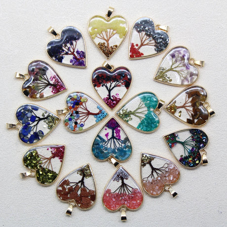 Heart-shaped pendants with nature-themed designs on a white background