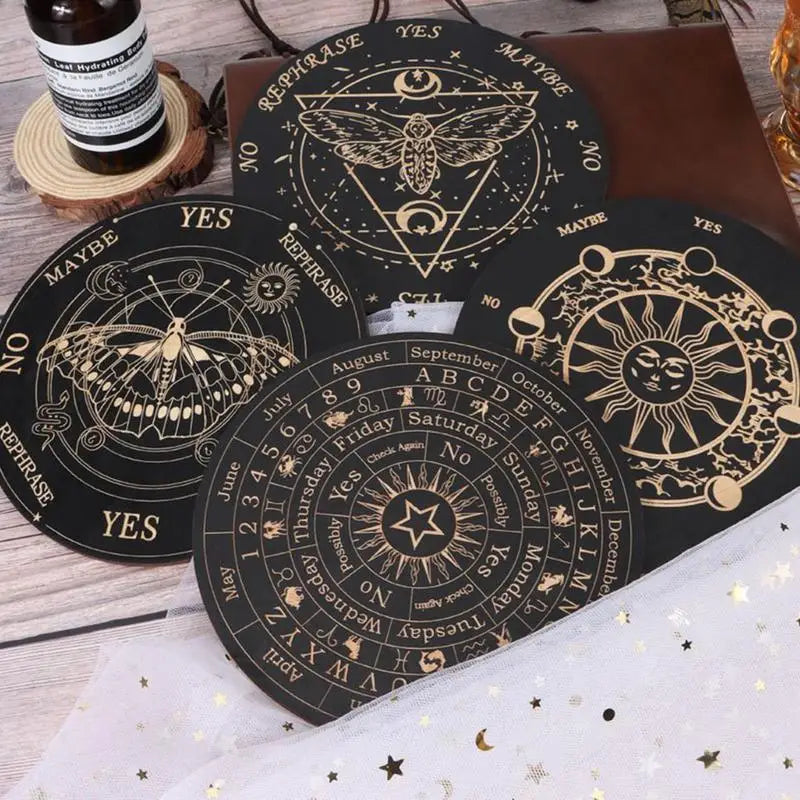 Set of black and gold tarot card coasters on a wooden surface.