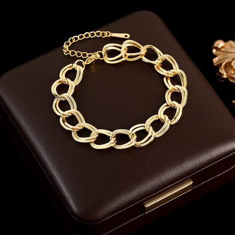 Gold chain bracelet on a black box