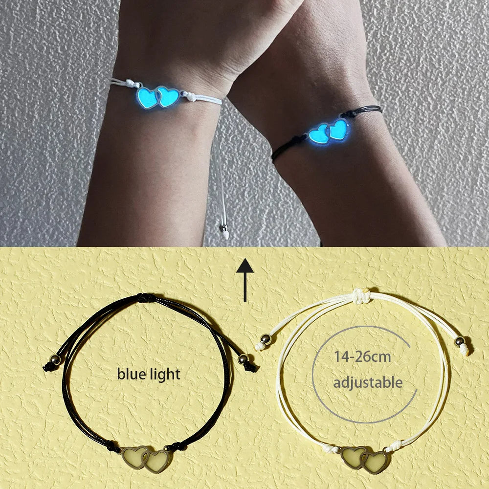 Glowing heart-shaped anklets on a person's ankle with close-up details of the anklets on a yellow background.
