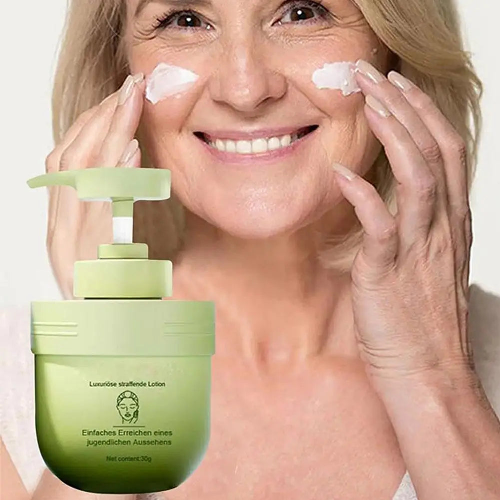 Woman applying cream to her face with a green skincare product in the foreground.