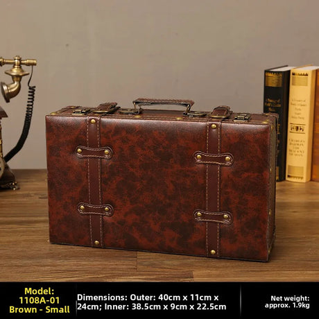 Brown vintage-style suitcase on a wooden surface with books and a phone in the background.