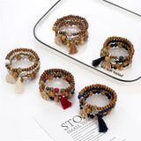 Set of beaded bracelets with tassels on a white surface