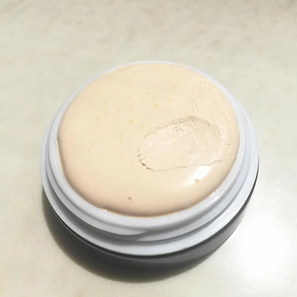 Cosmetic cream in a round container on a light background