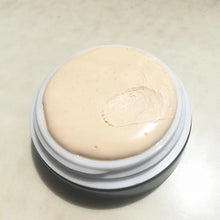 Cosmetic cream in a round container on a light background