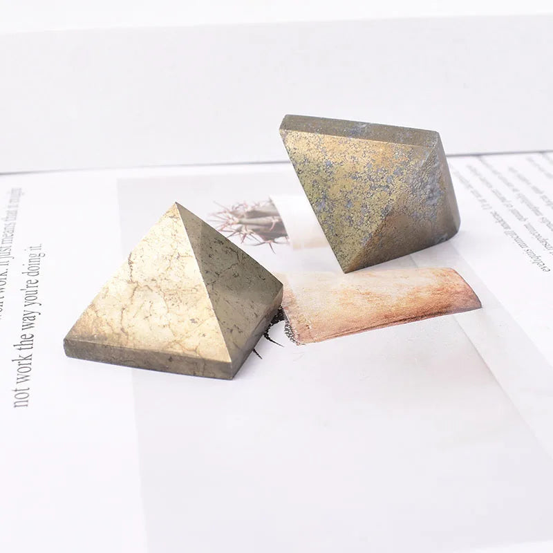 Two triangular stone objects on a white surface with text in the background
