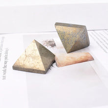 Two triangular stone objects on a white surface with text in the background