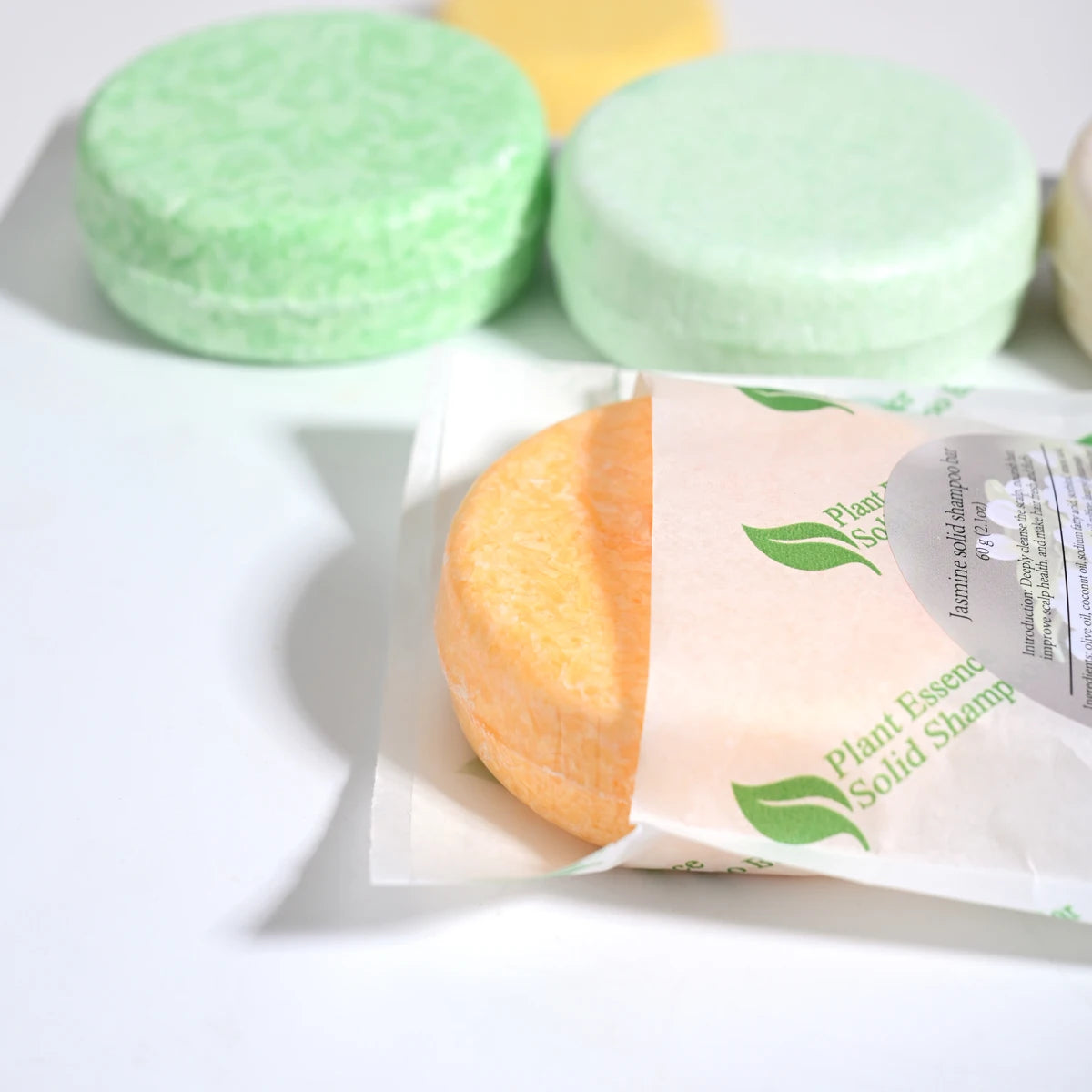 Solid shampoo bars with packaging on a white background