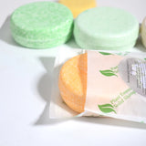 Solid shampoo bars with packaging on a white background
