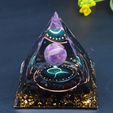 Decorative pyramid with a purple crystal ball on a dark background