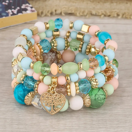Colorful beaded bracelet with heart charm on a wooden surface