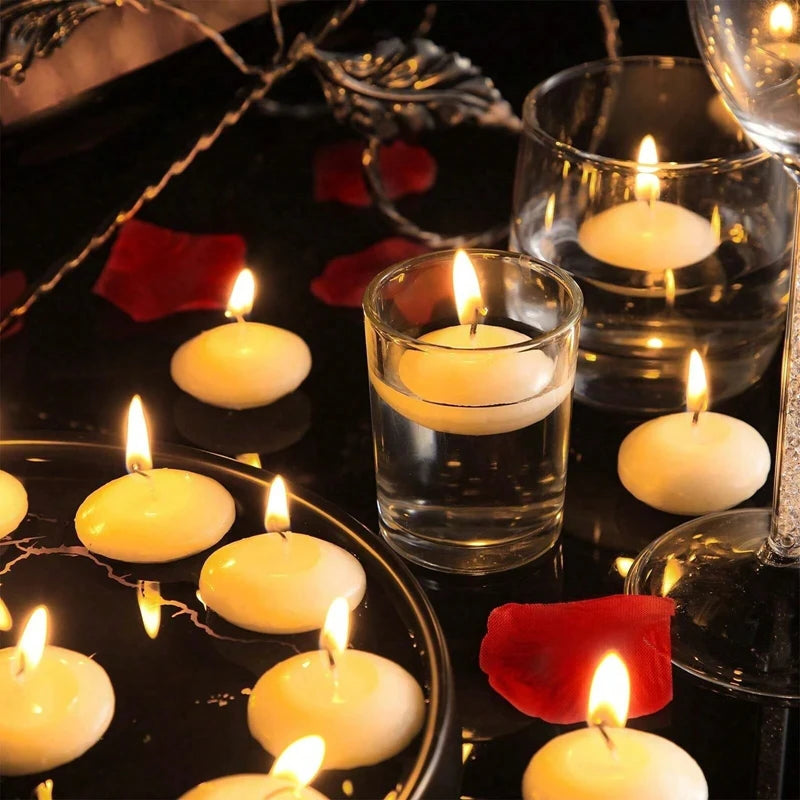 Candlelit scene with floating candles and red rose petals on a dark surface.