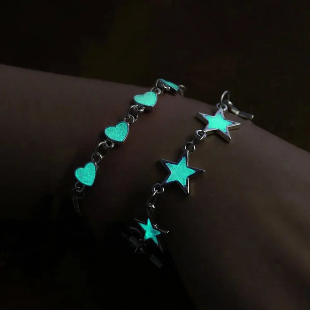 Bracelet with glowing turquoise stars and hearts on a dark background