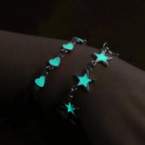 Bracelet with glowing turquoise stars and hearts on a dark background