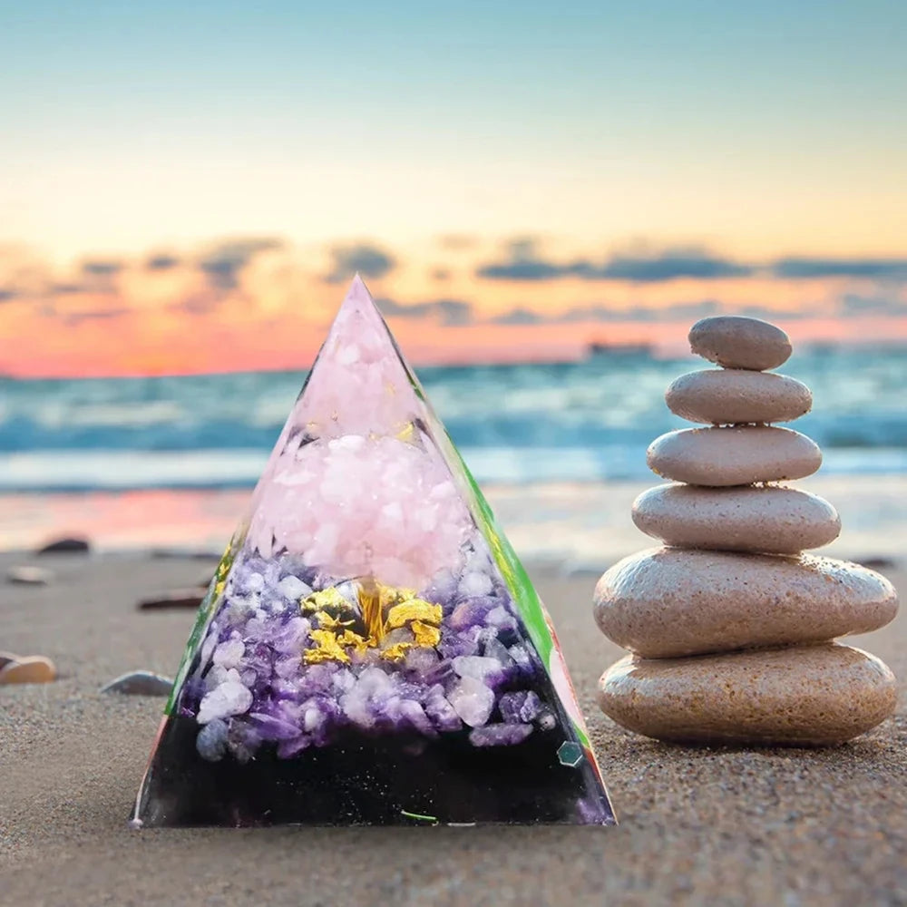 Decorative pyramid with stones on a beach at sunset