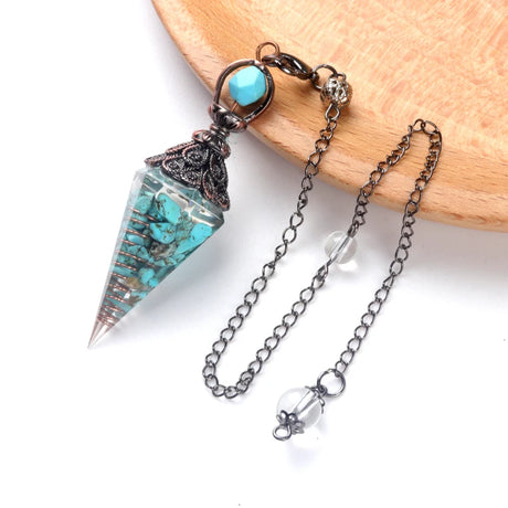 Turquoise crystal pendant with chain on a white background