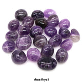 Collection of purple amethyst stones on a white background
