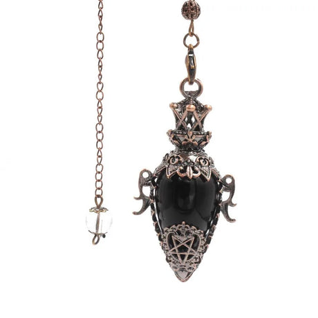 Decorative pendant with black stone and intricate designs on a white background