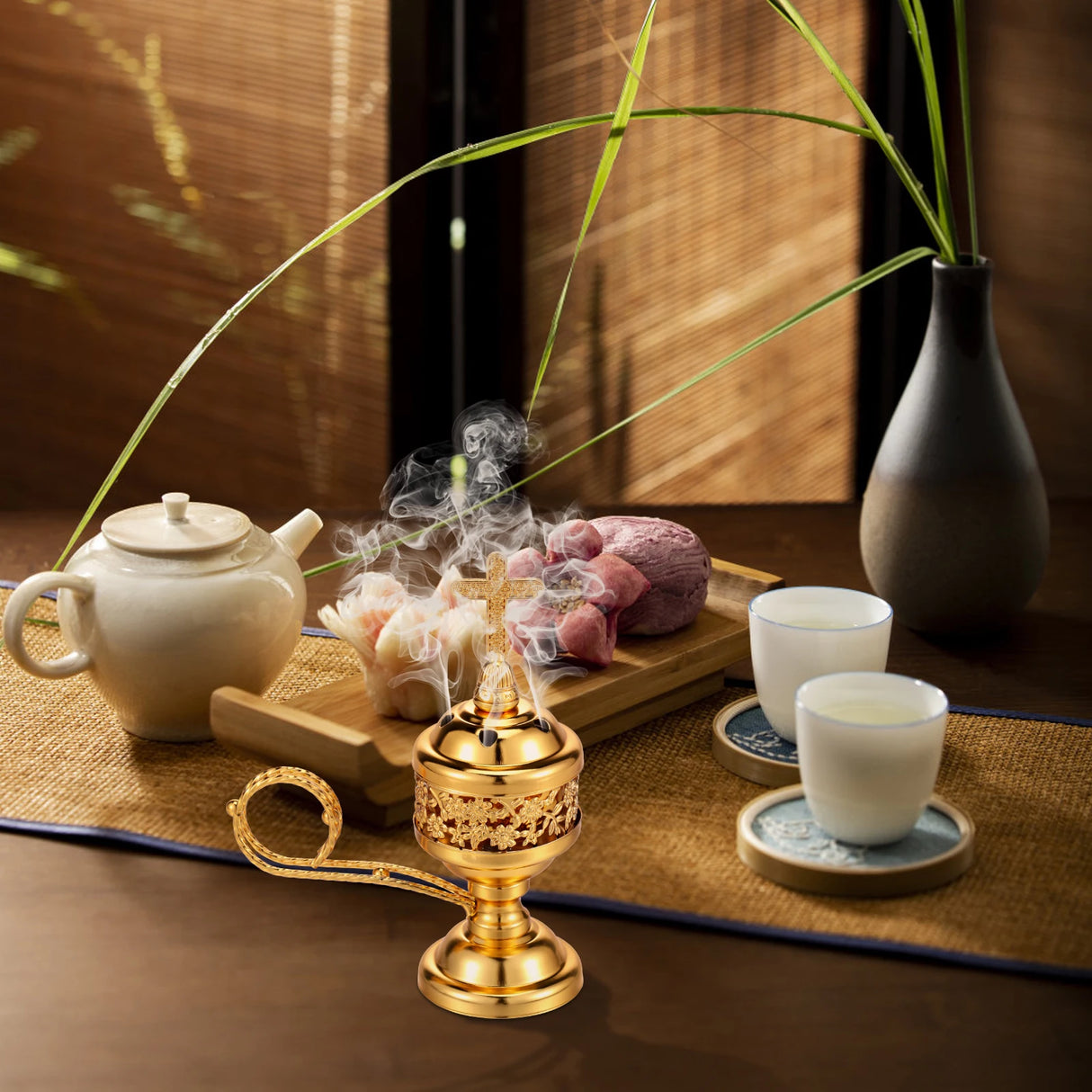 Tea set with teapot, cups, and incense burner on a wooden table.