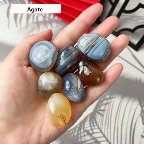 Hand holding agate stones with a blurred background