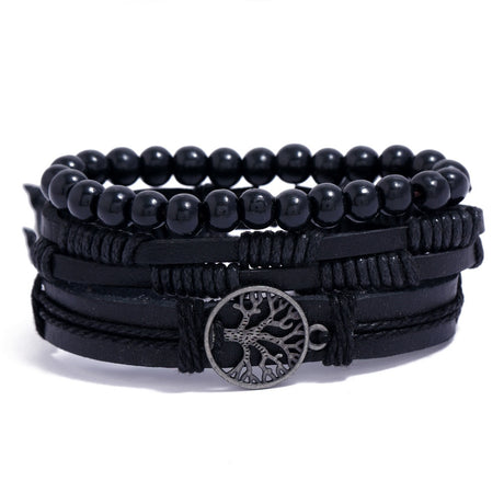 Black beaded and leather wrap bracelet with a tree of life charm on a white background