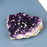 Amethyst crystal cluster on a blue background