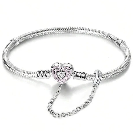 Silver bracelet with a heart-shaped clasp on a white background